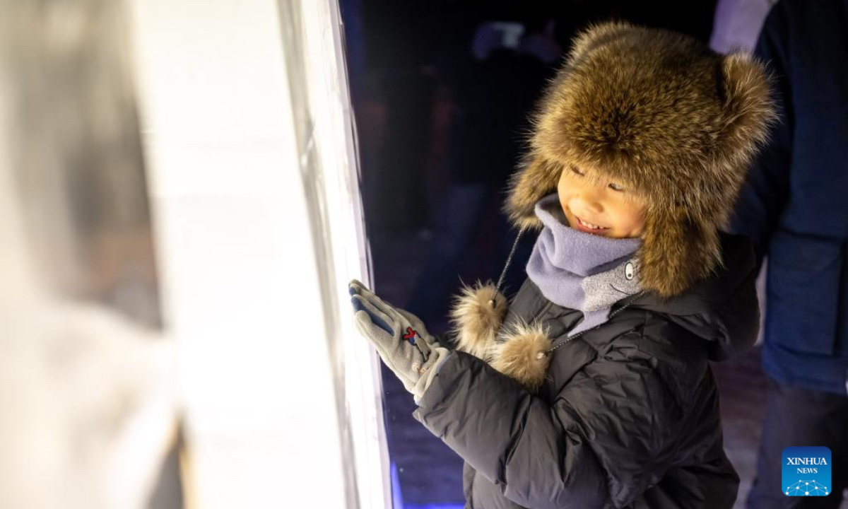 A child plays at an ice and snow theme park in Manzhouli, north China's Inner Mongolia Autonomous Region, Dec. 20, 2025. The 22nd China-Russia-Mongolia international ice and snow festival opened here on Saturday. The theme park created for the festival covers an area of 128,000 square meters. (Xinhua/Lian Zhen)