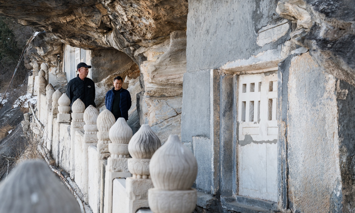 Tourists walk outside the caves storing sacred scriptures atop the Shijing Mountain on December 15, 2025. Photo: Chen Tao/GT