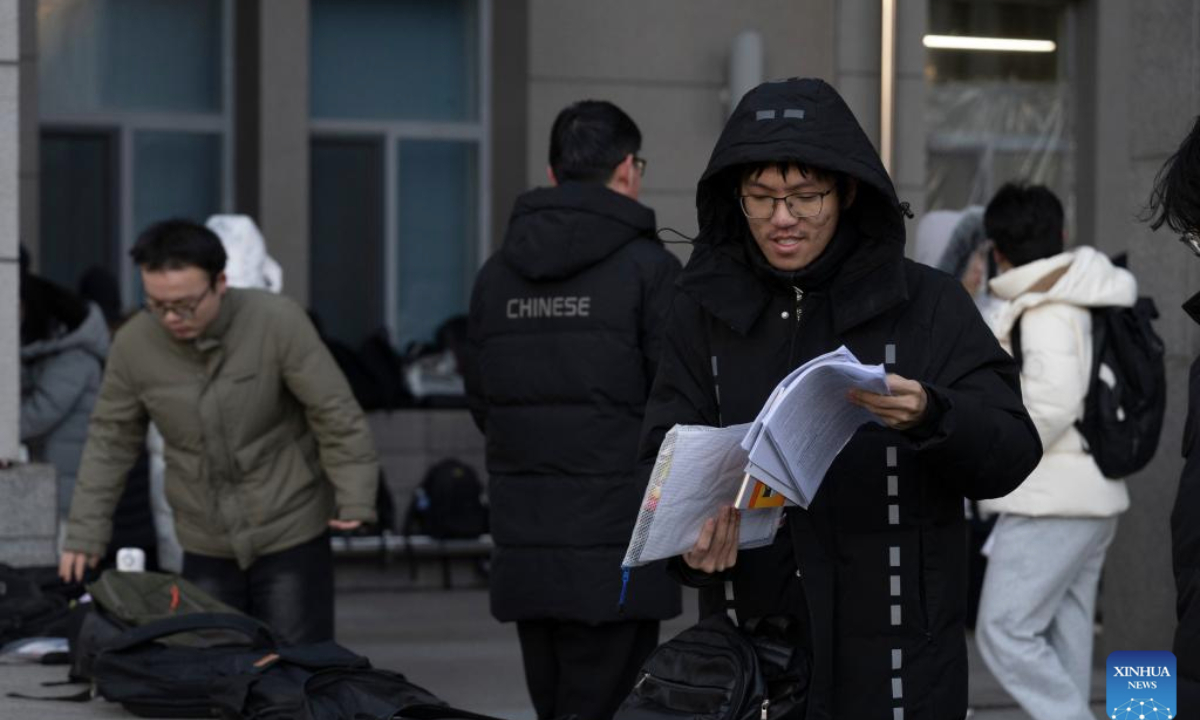 Examinees prepare to enter an examination site for the 2026 postgraduate entrance exam in Harbin, northeast China's Heilongjiang Province, Dec. 20, 2025. China's national exam for postgraduate enrolment kicked off on Saturday. (Xinhua/Zhang Tao)