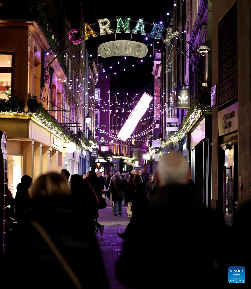 People walk on Carnaby Street decorated with lights in London, Britain, on Dec. 17, 2025. (Xinhua/Li Ying)