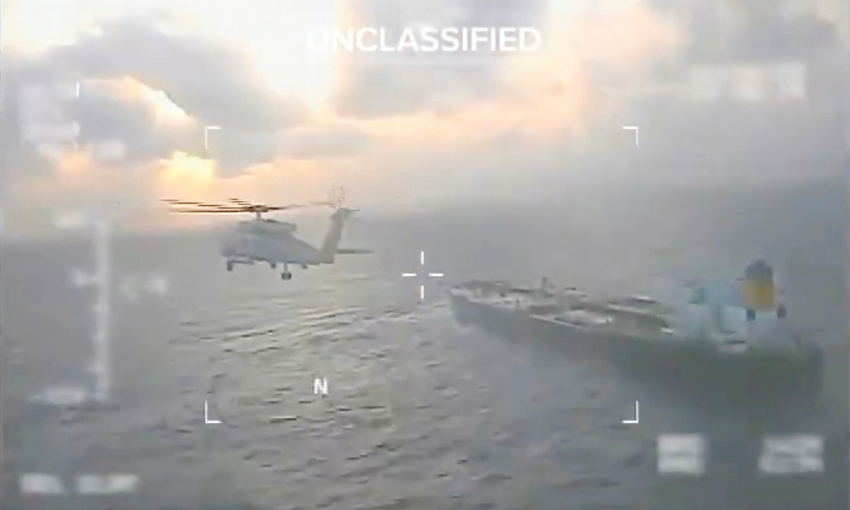 This screen grab taken from a video posted on the X account of US Secretary of Homeland Security Kristi Noem shows a US Coast Guard aircraft flying over a crude oil tanker, last docked in Venezuela, before apprehending it on December 20, 2025. Photo: VCG