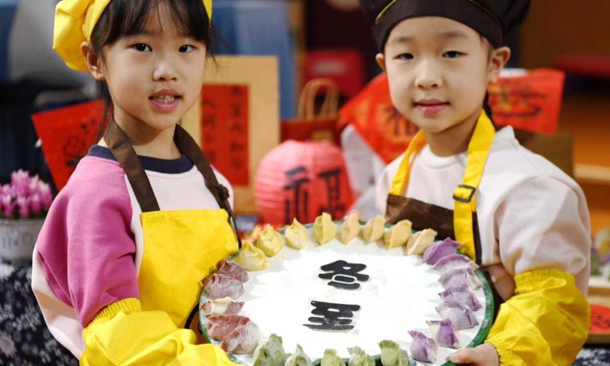 Children present the dumplings they made at a kindergarten in Jiyuan City, east China's Shandong Province, Dec. 19, 2025. Winter Solstice, the shortest day of the year, which will fall on Dec. 21 this year, denotes the beginning of deep winter and a break from farming in traditional agricultural society in Chinese culture. Northern China has maintained the tradition of eating dumplings on this day, while people in southern China eat tangyuan (glutinous rice balls). (Photo by Duan Erping/Xinhua)