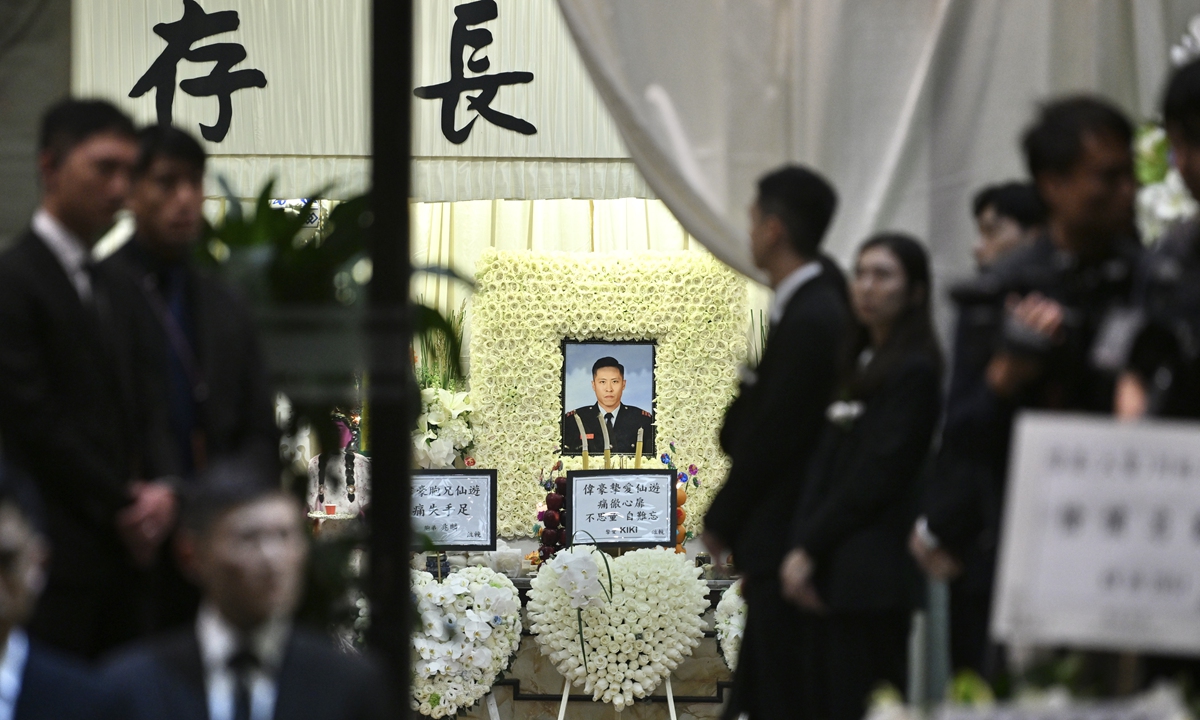 A portrait of the late fireman Ho Wai-ho in his Fire Services uniform is displayed at the center of the funeral hall. Photo: IC