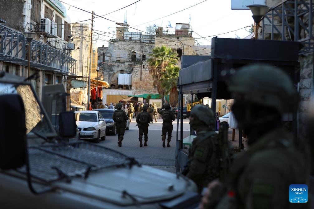 Members of Israeli forces secure the streets for Israeli settlers in the Old City of Hebron in the southern West Bank, on Dec. 20, 2025. (Photo by Mamoun Wazwaz/Xinhua)