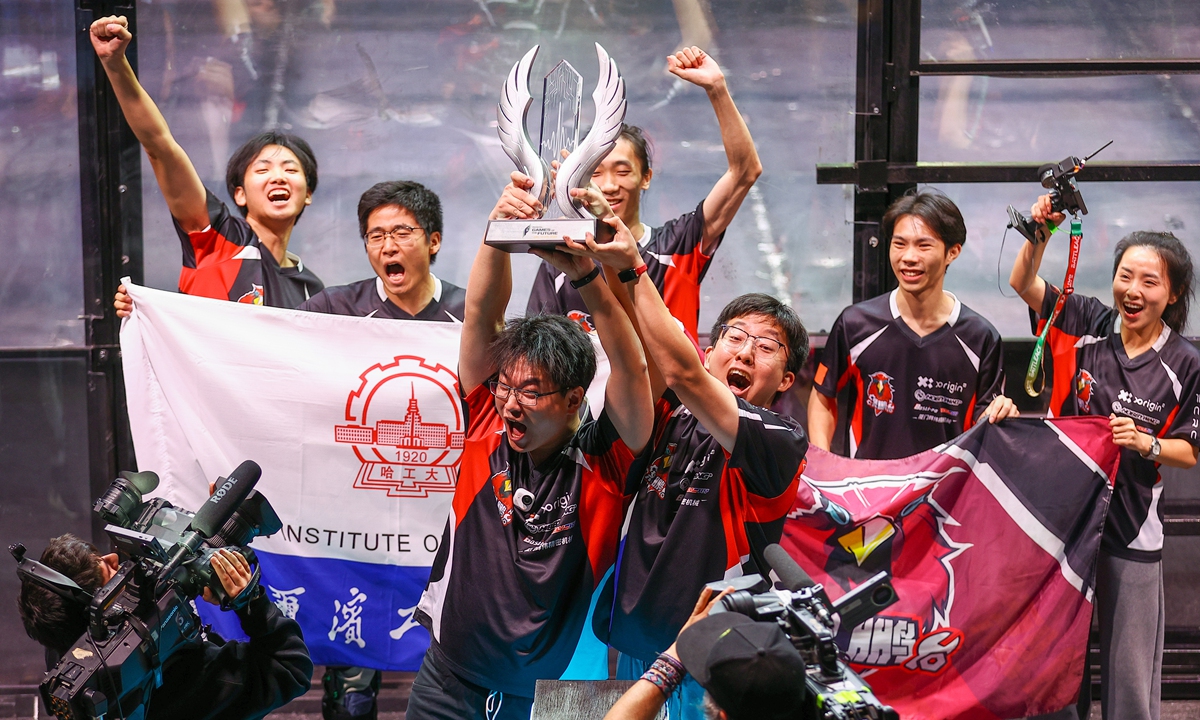 China's Fierce Roc team celebrates victory in the Battle of Robots event during Games of the Future 2025 at the Abu Dhabi National Exhibition Centre, on December 21, 2025. Their combat robot, named Deep Sea Shark 3, delivered several knockouts to its opponents during the competition. Photo: VCG