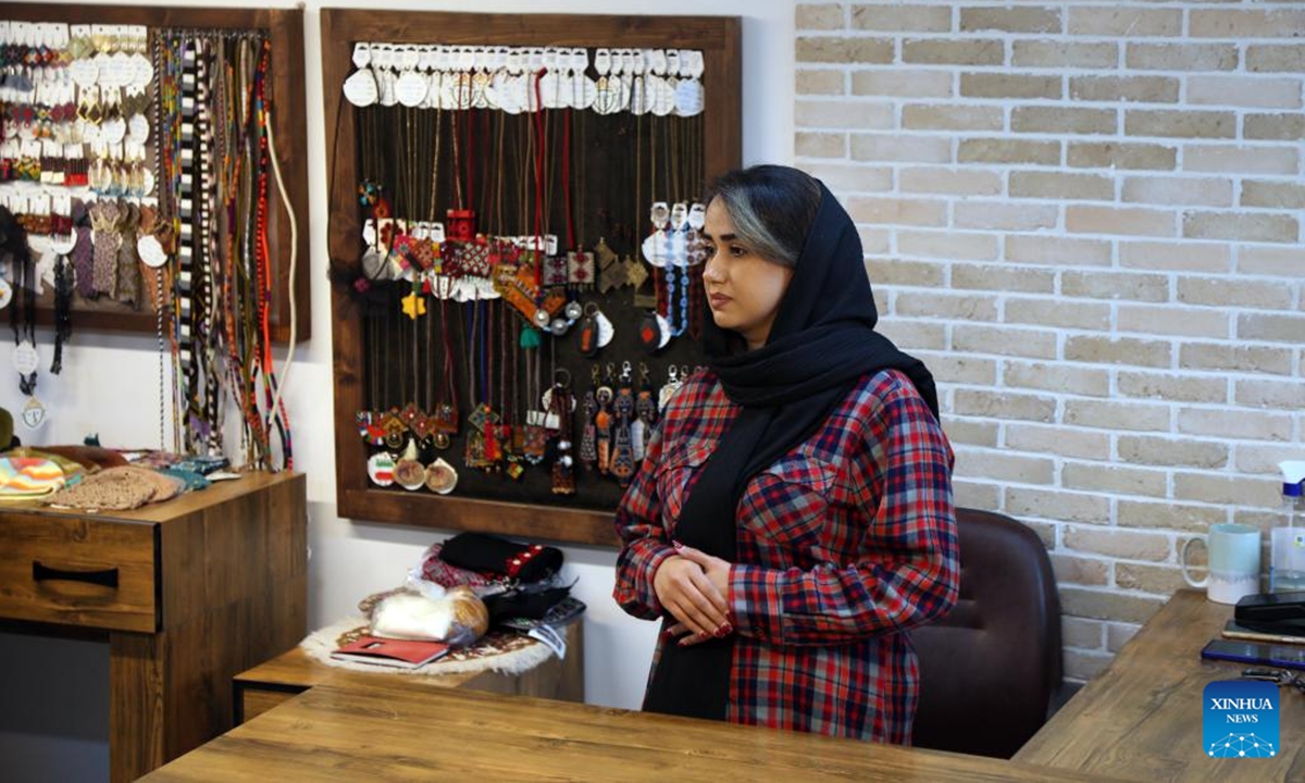 A woman is pictured at a traditional handicraft shop in Zahedan, capital of Sistan and Baluchestan province, Iran, Dec. 18, 2025. Bordering Pakistan and Afghanistan, Sistan and Baluchestan province is located in southeastern Iran. (Xinhua/Shadati)