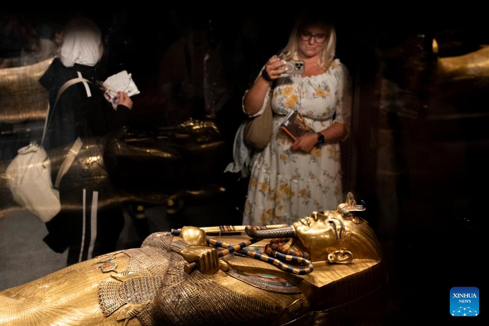 People view the Solid Gold Inner Coffin of Tutankhamun at the King Tutankhamun exhibition hall of the Grand Egyptian Museum in Giza, Egypt, on Dec. 20, 2025. The Grand Egyptian Museum (GEM) opened its doors to the public on Nov. 4, establishing itself as one of the world's largest displays of ancient relics, and a high-tech fort dedicated to heritage conservation.

The main galleries display thousands of previously stored antiquities for the first time, housing the complete collection of some 5,992 artifacts from the tomb of the boy-king Tutankhamun. (Xinhua/Xin Mengchen)
