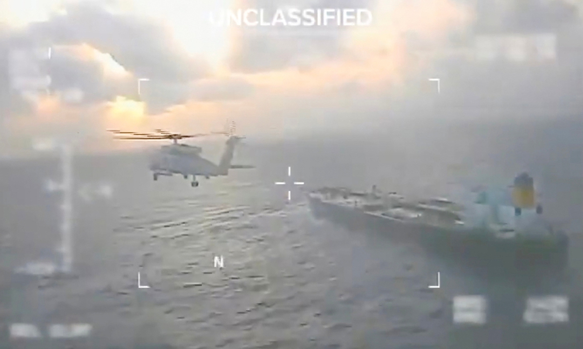This screen grab taken from a video posted on the X account of US Secretary of Homeland Security Kristi Noem shows a US Coast Guard aircraft flying over a crude oil tanker, last docked in Venezuela, before apprehending it on December 20, 2025. Photo: VCG