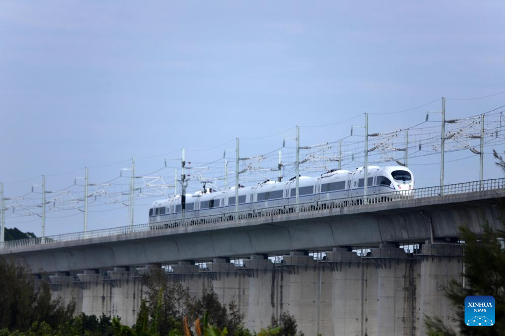 This photo taken on Dec. 22, 2025 shows a high-speed train running on the Haojiang grand bridge in south China's Guangdong Province. The Shantou-Shantou South section of the 162-km-long Shantou-Shanwei high-speed railway was completed and opened to traffic on Monday, marking the full-line operation of the railway. (Photo by Yao Jun/Xinhua)