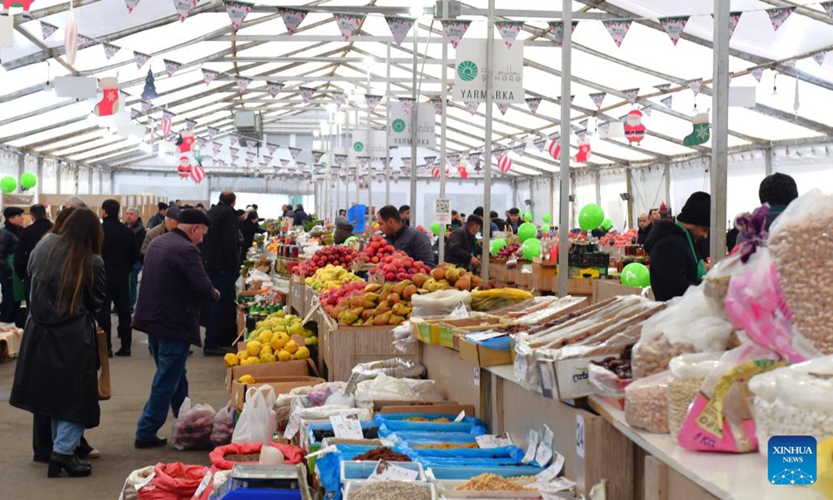 People attend an agricultural products trade fair in Baku, Azerbaijan, Dec. 21, 2025. With more than 140 specialties from over 80 farms and agricultural product processing enterprises across the country, the trade fair opened here on Saturday, and will run through Dec. 30. (Xinhua/Chen Junfeng)