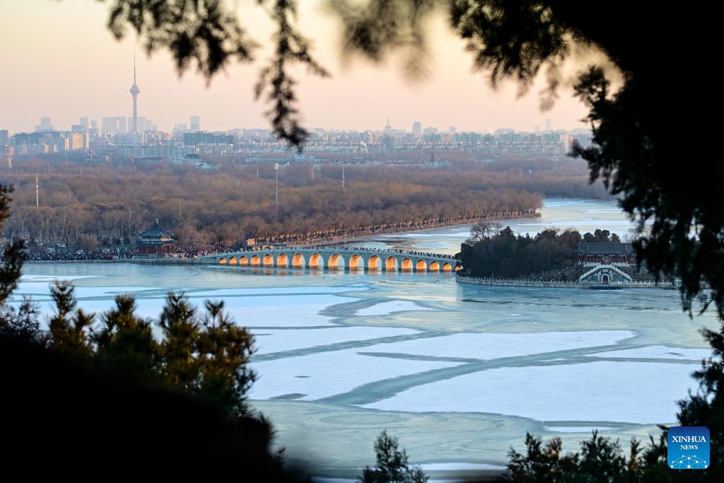 This photo taken on Dec. 21, 2025 shows the Seventeen-Arch Bridge with the sunset glow shining through its arches at the Summer Palace in Beijing, capital of China. (Xinhua/Chen Yehua)