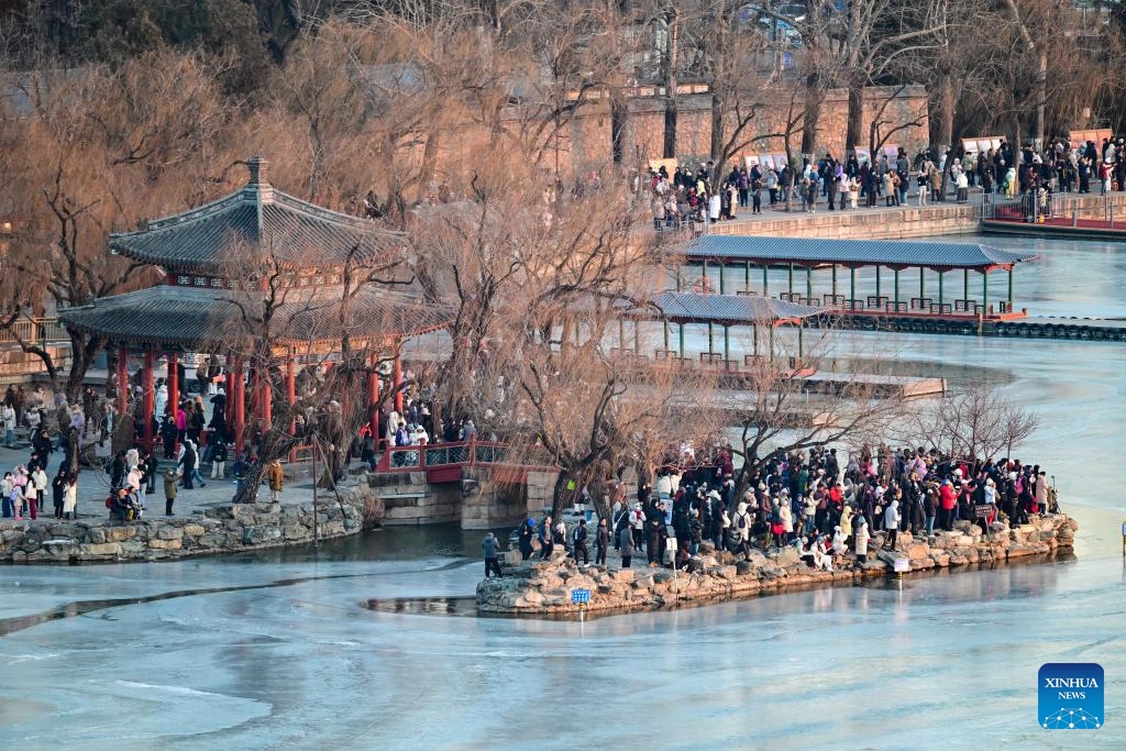 This photo taken on Dec. 21, 2025 shows the Seventeen-Arch Bridge with the sunset glow shining through its arches at the Summer Palace in Beijing, capital of China. (Xinhua/Chen Yehua)