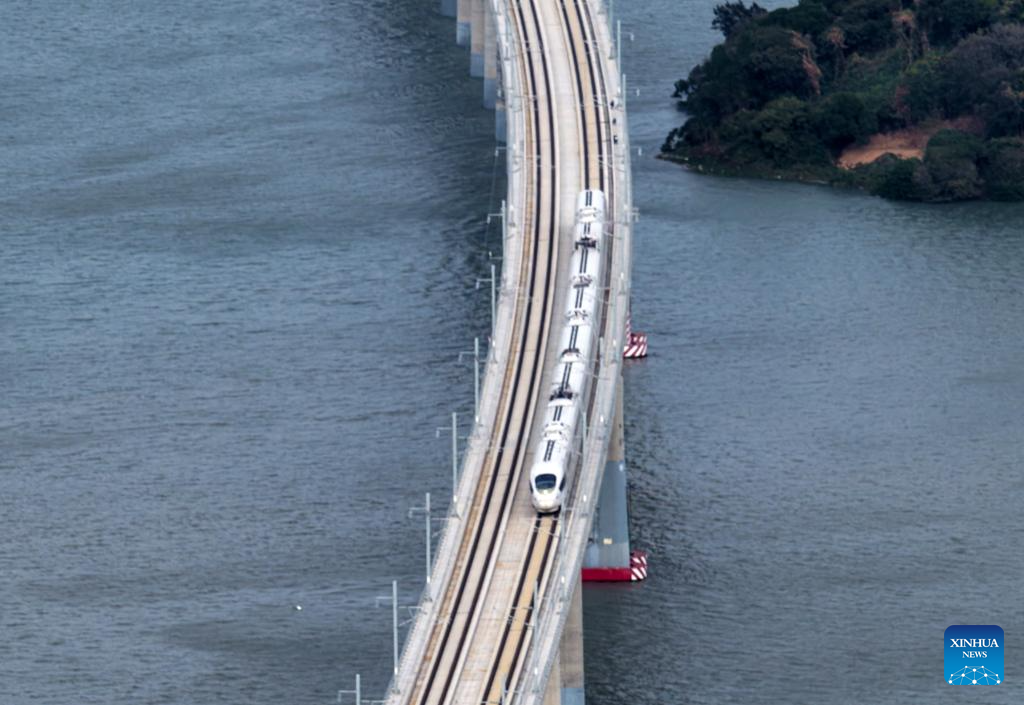 This photo taken on Dec. 22, 2025 shows a high-speed train running on the Haojiang grand bridge in south China's Guangdong Province. The Shantou-Shantou South section of the 162-km-long Shantou-Shanwei high-speed railway was completed and opened to traffic on Monday, marking the full-line operation of the railway. (Photo by Yao Jun/Xinhua)