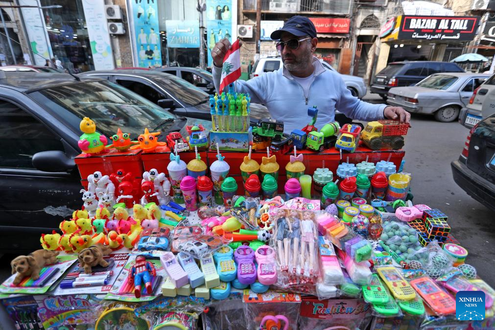 A vendor prepares his merchandise for Christmas in Tripoli, northern Lebanon, on Dec. 22, 2025. (Photo by Bilal Jawich/Xinhua)