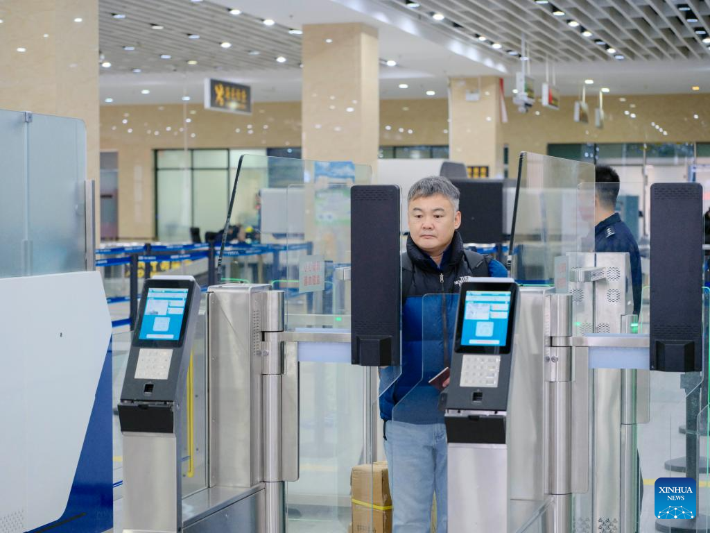 A passenger goes through border inspection procedures at a land port in Erenhot, north China's Inner Mongolia Autonomous Region, Dec. 22, 2025. Erenhot, the largest land port on the China-Mongolia border, is a pivotal point of the China-Mongolia-Russia Economic Corridor. As of Dec. 22, inbound and outbound passenger traffic volumes and the number of vehicles driving through Erenhot reached 2.753 million and 741,000, respectively, up by 8.8 percent and 12.1 percent compared with the same period of last year. (Xinhua/Ma Jinrui)