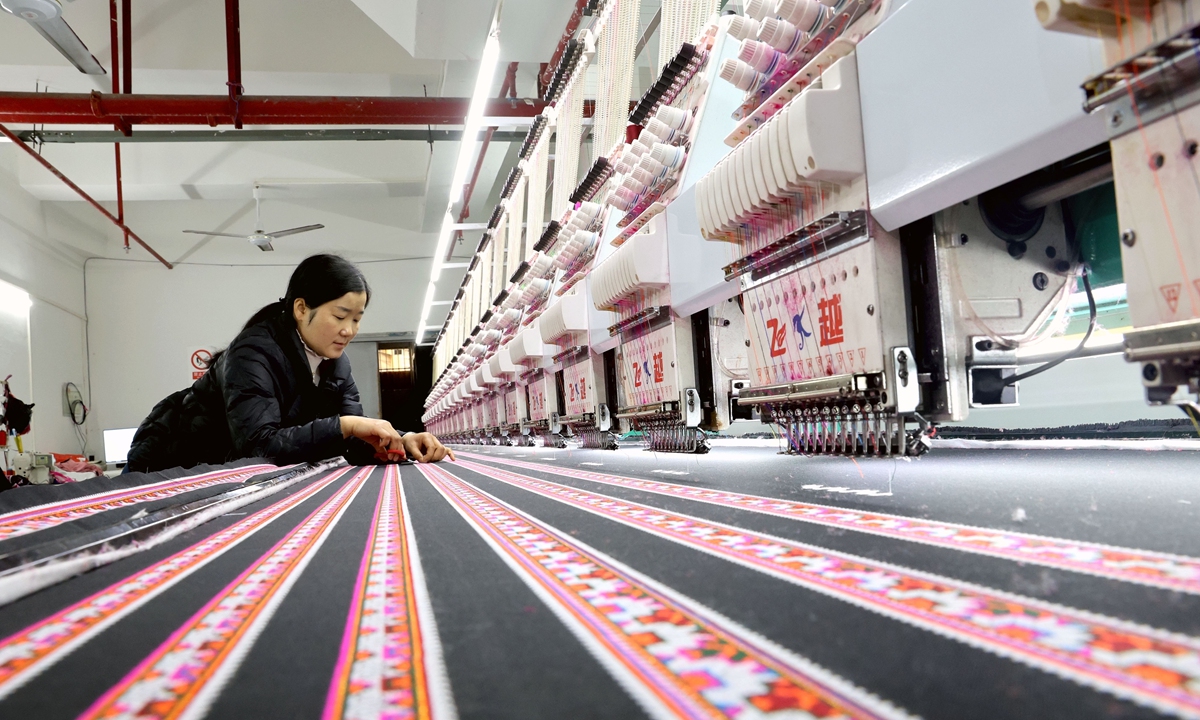 A worker produces ethnic embroidery products in a workshop in Rongjiang county, Southwest China's Guizhou Province on December 23, 2025. In recent years, the province has increased efforts to help villagers find jobs and increase their incomes near their homes, according to the Xinhua News Agency. Photo: VCG