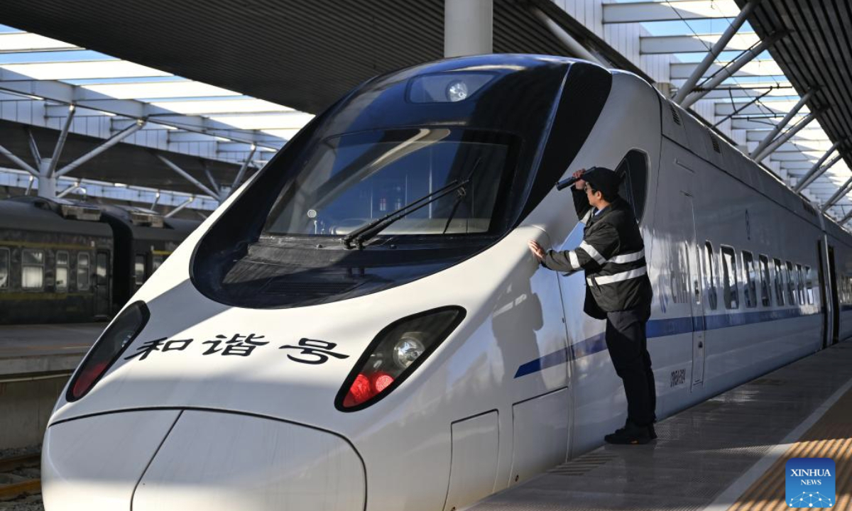 A staff member checks the first train of the Baotou-Yinchuan High-Speed Railway at Baotou Railway Station in Baotou, north China's Inner Mongolia Autonomous Region, Dec. 23, 2025. The Baotou-Huinong section of the Baotou-Yinchuan High-Speed Railway was completed and opened to traffic on Tuesday, marking the full-line operation of the railway. (Xinhua/Li Zhipeng)