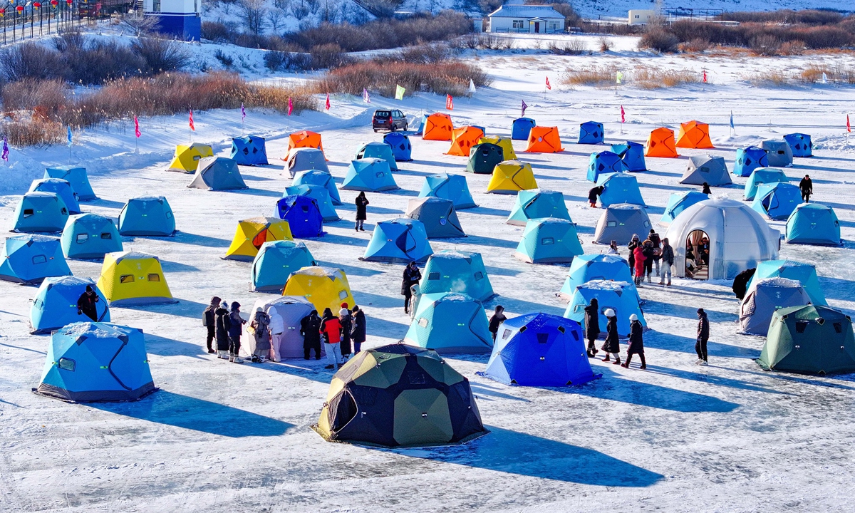 Tourists try out ice fishing at a scenic spot in Ergun City, Hulun Buir in North China's Inner Mongolia Autonomous
Region on December 23, 2025. Relying on its unique geographical and climatic conditions, the city has launched a series of distinctive products including border river ice fishing, snowfield horseback riding, cross-border shopping, and folk cuisine. Photo: VCG