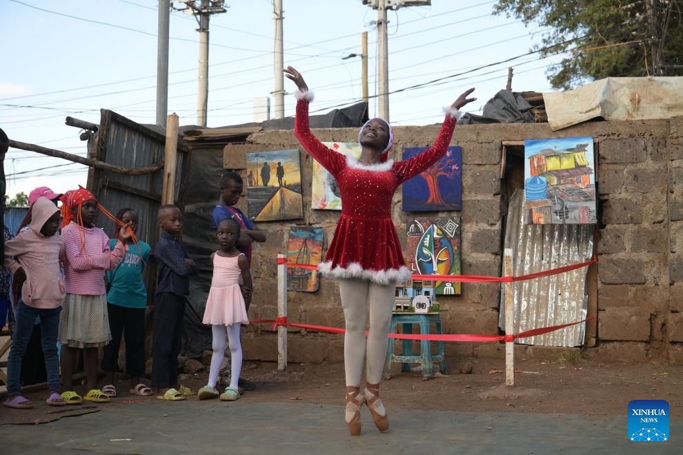 A young dancer performs on a simple stage at the Kibera slum in Nairobi, Kenya, Dec. 23, 2025. A Christmas ballet performance organized by the Kibera Ballet School was held here on Tuesday, attracting many local residents to watch. (Xinhua/Yang Guang)