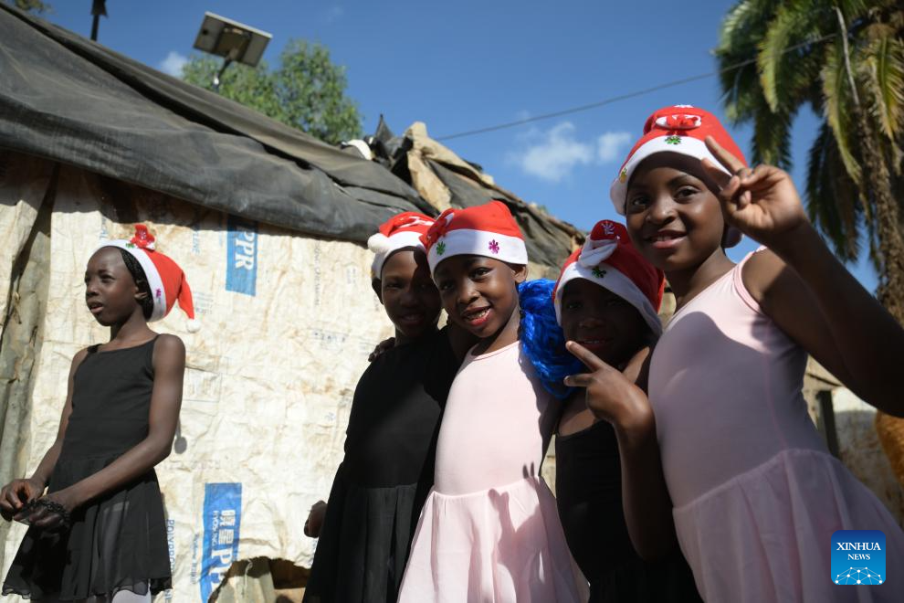 Young dancers pose for photos before attending a ballet performance at the Kibera slum in Nairobi, Kenya, Dec. 23, 2025. A Christmas ballet performance organized by the Kibera Ballet School was held here on Tuesday, attracting many local residents to watch. (Xinhua/Yang Guang)