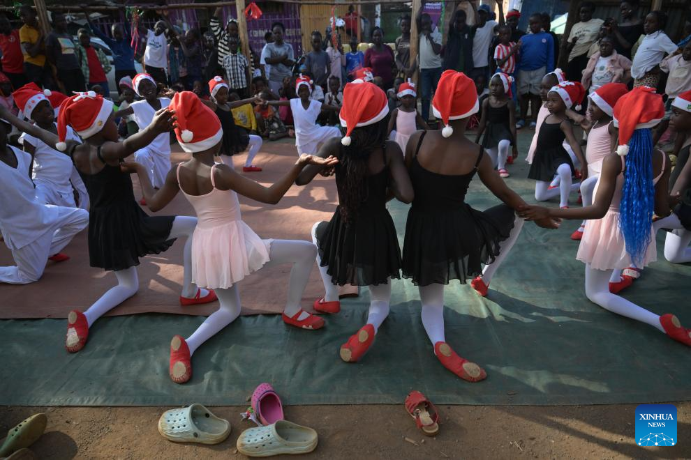 Young dancers perform on a simple stage at the Kibera slum in Nairobi, Kenya, Dec. 23, 2025. A Christmas ballet performance organized by the Kibera Ballet School was held here on Tuesday, attracting many local residents to watch. (Xinhua/Yang Guang)