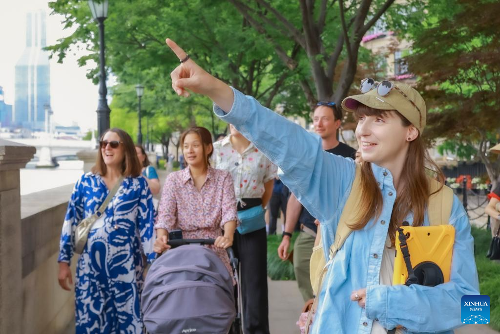 Clarisse Le Guernic leads foreign tourists on a citywalk tour in east China's Shanghai, on May 13, 2025. (Xinhua)