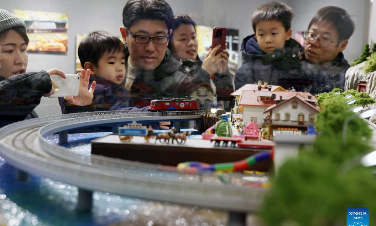 People visit a model train exhibition in Shanghai, east China, Dec. 27, 2025. The theme exhibition and related special activities were held at Shanghai Mass Art Center on Saturday. More than 50 model trains shuttled among ten theme scenes, presenting visitors with a wonderful miniature world about trains and railways. (Xinhua/Liu Ying)