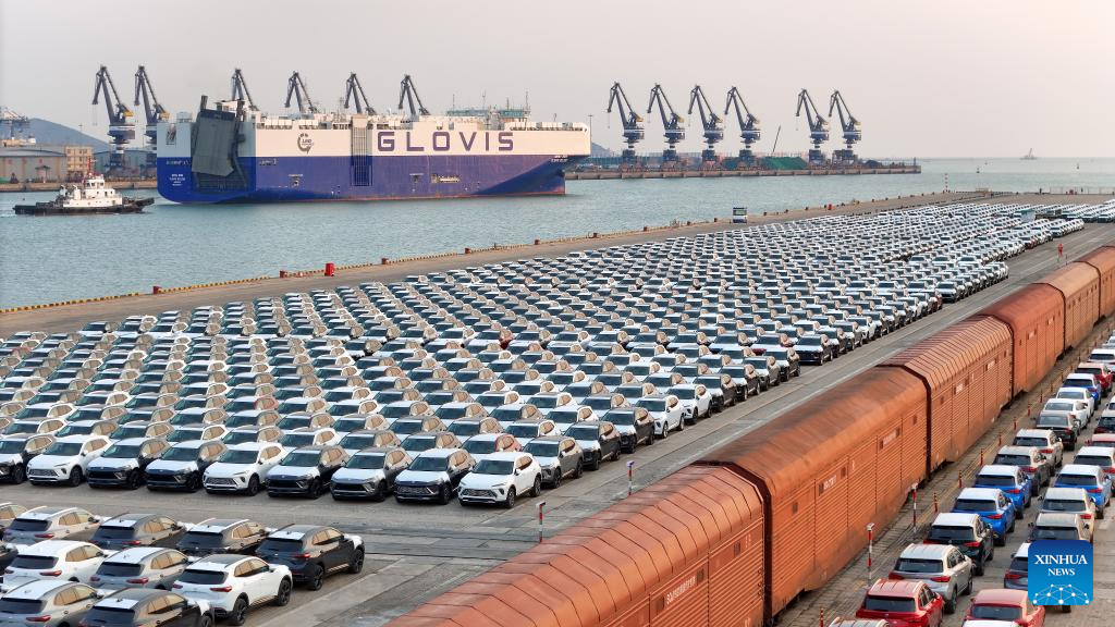 This aerial drone photo taken on Dec. 27, 2025 shows vehicles to be exported at Yantai Port in east China's Shandong Province. Shandong's port cargo throughput this year exceeded 1.9 billion tonnes on Saturday, with container volume surpassing 47 million TEUs. (Photo by Tang Ke/Xinhua)
