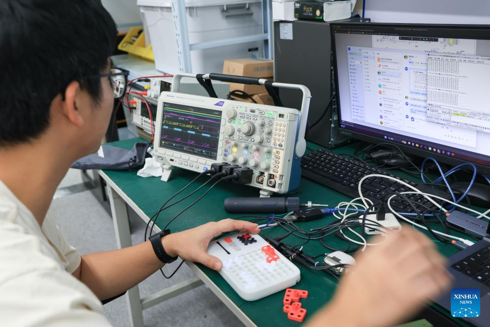 A R&D staff member tests an intelligent blocks toy at the headquarters of Giiker in Shunde, Foshan City, south China's Guangdong Province, Oct. 29, 2025. As traditional toys are stuck in price and homogenization competition, a batch of smart educational toys is quietly opening up new markets at home and abroad. (Xinhua/Mao Siqian)