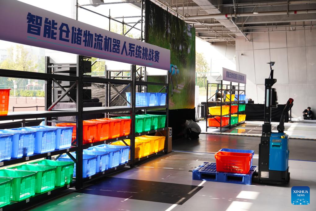This photo shows a competition of intelligent warehouse logistics robot system during a robot skills competition in Shenzhen, south China's Guangdong Province, Dec. 27, 2025. The robot skills competition kicked off here on Friday and will last till Dec. 30, 2025. Over 100 teams participate in robot application matches ranging from industrial manufacturing, healthcare to emergency rescue scenarios. (Xinhua/Wang Feng)