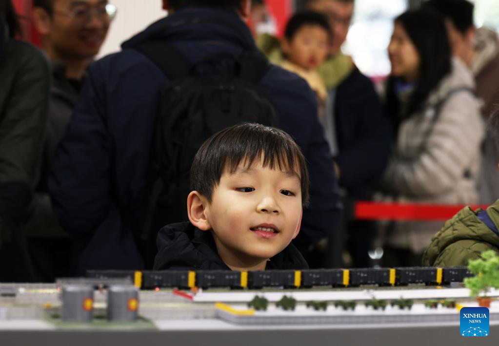 A boy visits a model train exhibition in Shanghai, east China, Dec. 27, 2025. The theme exhibition and related special activities were held at Shanghai Mass Art Center on Saturday. More than 50 model trains shuttled among ten theme scenes, presenting visitors with a wonderful miniature world about trains and railways. (Xinhua/Liu Ying)