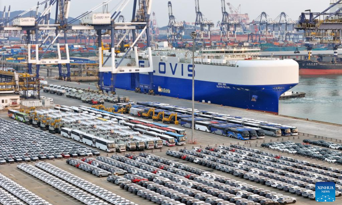 This aerial drone photo taken on Dec. 27, 2025 shows vehicles to be exported at Yantai Port in east China's Shandong Province. Shandong's port cargo throughput this year exceeded 1.9 billion tonnes on Saturday, with container volume surpassing 47 million TEUs. (Photo by Tang Ke/Xinhua)