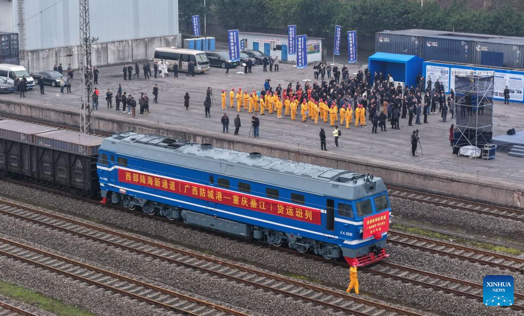 An aerial drone photo taken on Dec. 29, 2025 shows the first freight train from Fangchenggang City of Guangxi to Qijiang District of Chongqing arriving at the Qijiang North railway station in southwest China's Chongqing Municipality. The first freight train of the Guangxi Fangchenggang-Chongqing Qijiang railway, part of China's New International Land-Sea Trade Corridor rail service which is a crucial logistics link between China's western inland regions and global markets, arrived at the Qijiang North railway station in Chongqing on Monday. (Xinhua/Chen Cheng)