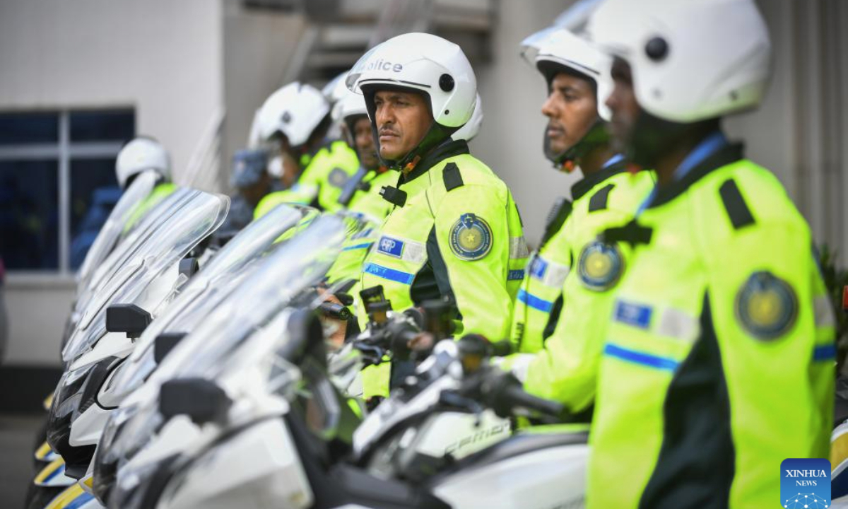 Ethiopian police officers stand next to the motorcycles donated by China to the Ethiopian Federal Police Commission in Addis Ababa, the capital of Ethiopia, Dec. 23, 2025. (Photo by Michael Tewelde/Xinhua)