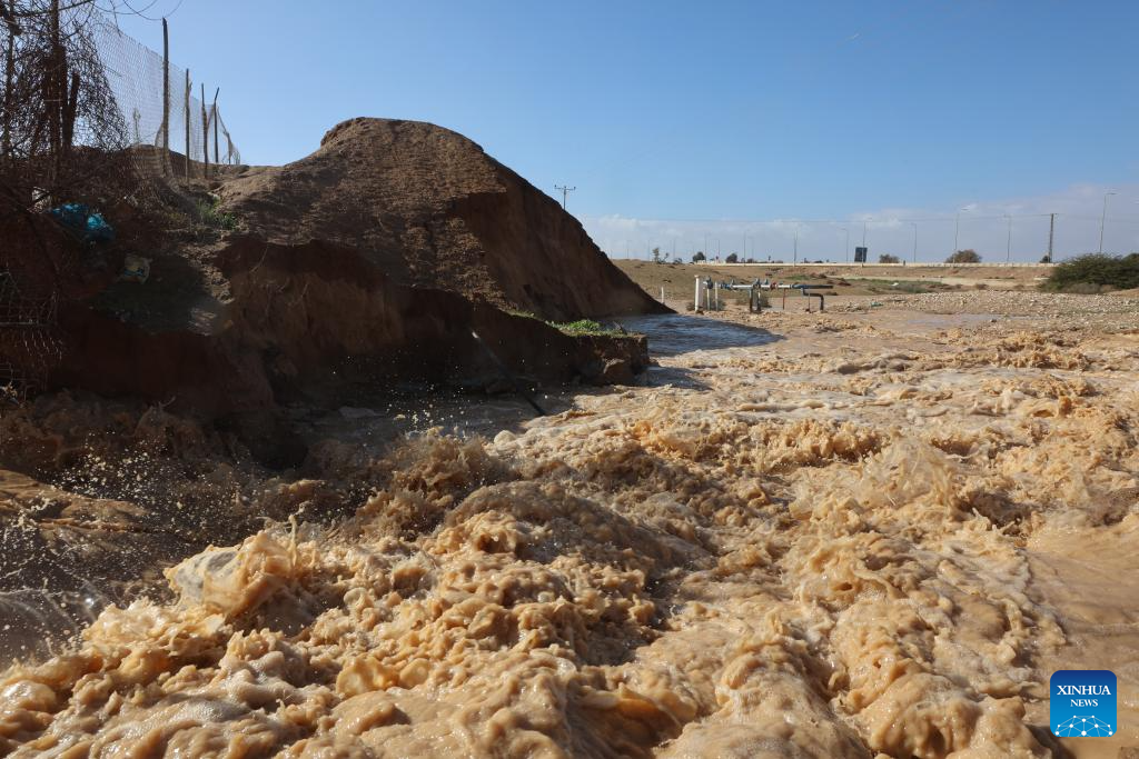 Floodwater breaches a riverbank in southern Israel on Dec. 28, 2025. Israel's winter rainy season frequently brings floods. (Photo by Gil Cohen Magen/Xinhua)