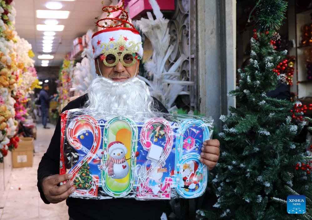 A man displays Christmas and New Year decorations at the Shorja market in Baghdad, Iraq, on Dec. 25, 2025. (Xinhua/Khalil Dawood)