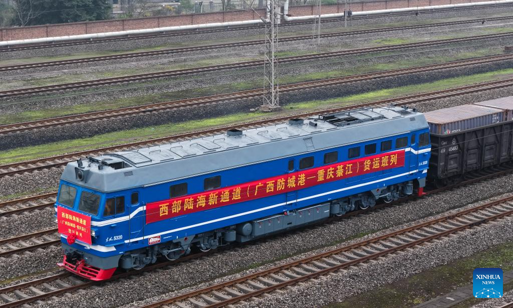 An aerial drone photo taken on Dec. 29, 2025 shows the first freight train from Fangchenggang City of Guangxi to Qijiang District of Chongqing arriving at the Qijiang North railway station in southwest China's Chongqing Municipality. The first freight train of the Guangxi Fangchenggang-Chongqing Qijiang railway, part of China's New International Land-Sea Trade Corridor rail service which is a crucial logistics link between China's western inland regions and global markets, arrived at the Qijiang North railway station in Chongqing on Monday. (Xinhua/Chen Cheng)