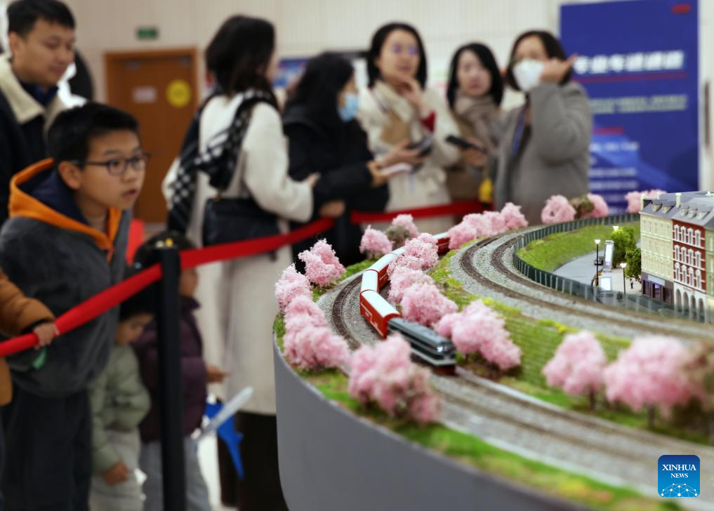 People visit a model train exhibition in Shanghai, east China, Dec. 27, 2025. The theme exhibition and related special activities were held at Shanghai Mass Art Center on Saturday. More than 50 model trains shuttled among ten theme scenes, presenting visitors with a wonderful miniature world about trains and railways. (Xinhua/Liu Ying)