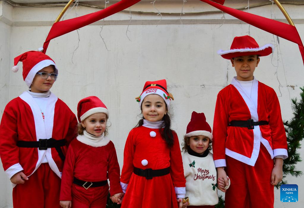 Photo taken on Dec. 25, 2025, shows Syrian kids dressed in Santa Claus outfits during a Christmas celebration in Damascus, Syria. (Photo by Ammar Safarjalani/Xinhua)