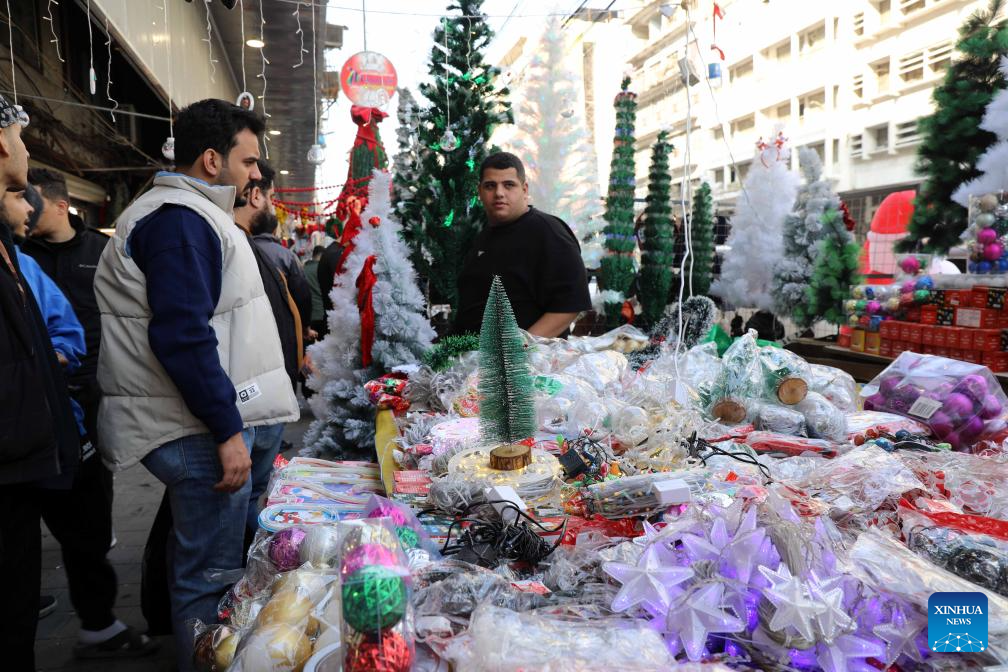 A man sells Christmas decorations at the Shorja market in Baghdad, Iraq, on Dec. 25, 2025. (Xinhua/Khalil Dawood)