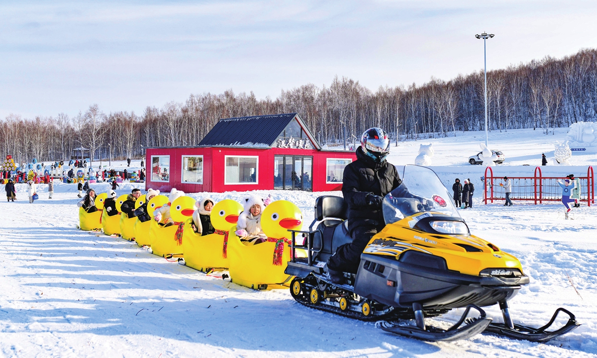 Tourists enjoy fun ice and snow sports at the Fenghuang Mountain Scenic Area in Yakeshi. 