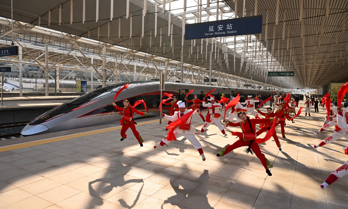 Residents put on an Ansai waist-drum performance, a traditional drum dance, in front of the C9312, the first train of the Xi'an-Yan'an high-speed railway at Yan'an Station in Northwest China's Shaanxi Province, on December 26, 2025. Photo: VCG