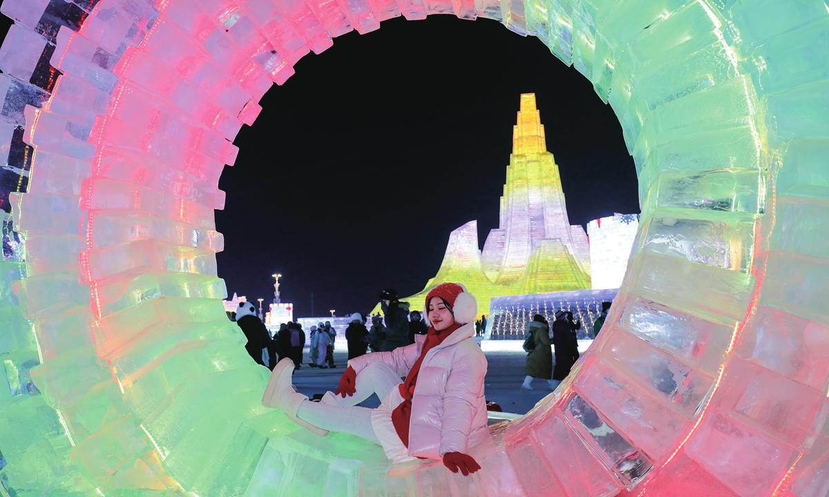 A tourist poses for a picture in the 27th Harbin Ice-Snow World in Harbin, Northeast China's Heilongjiang Province, on December 20, 2025. Photos on this page: VCG