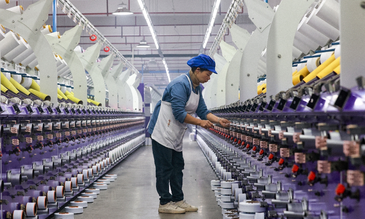 A worker operates a production line at a sportswear company in Qiandongnan, Southwest China's Guizhou Province, on December 26, 2025. As year-end approaches, workers are ramping up production to fulfill orders, pushing through the fourth quarter to meet full-year targets. Photo: VCG