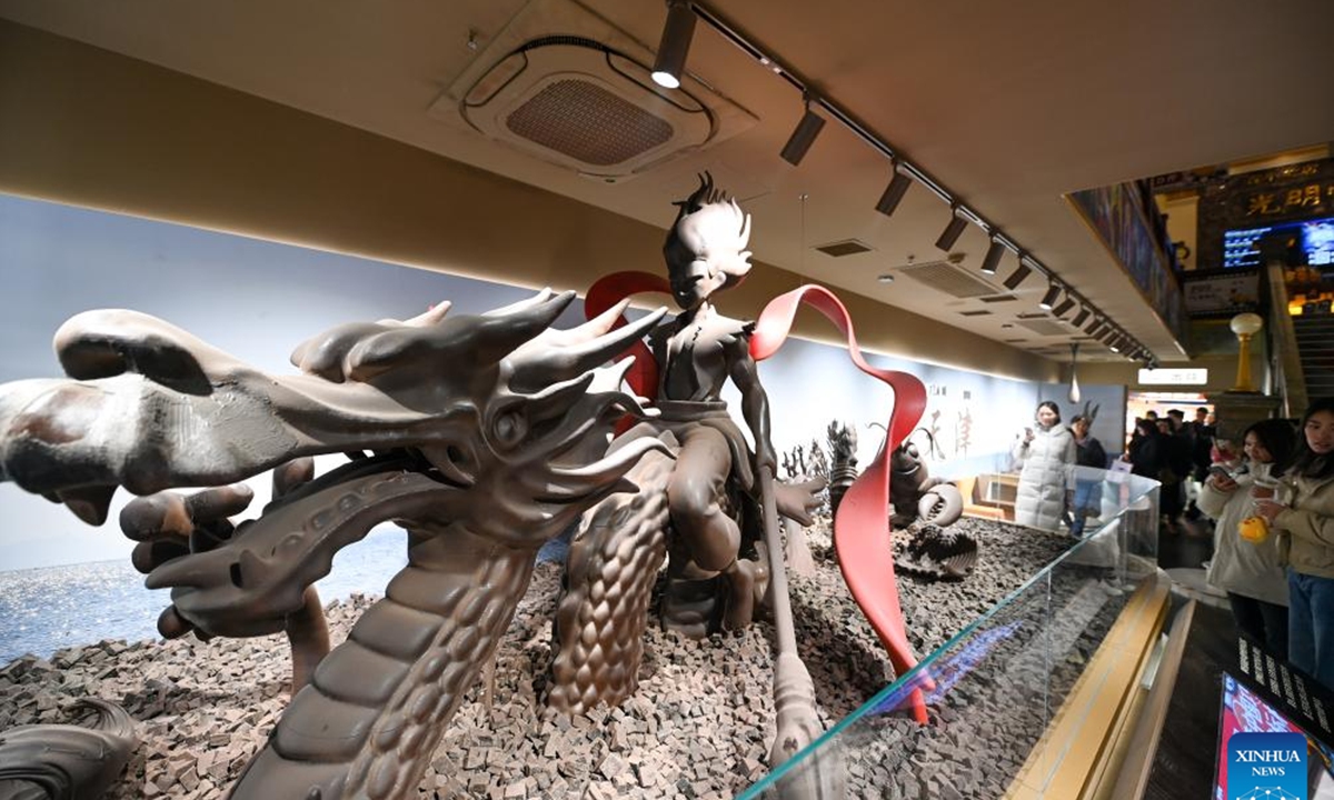 Tourists visit a chocolate museum in Tianjin, north China, Dec. 28, 2025. A chocolate museum has officially opened to the public in Tianjin. The museum displays more than 20 sets of handmade chocolate sculptures, with a total chocolate usage of nearly 10 tonnes. (Xinhua/Zhao Zishuo)