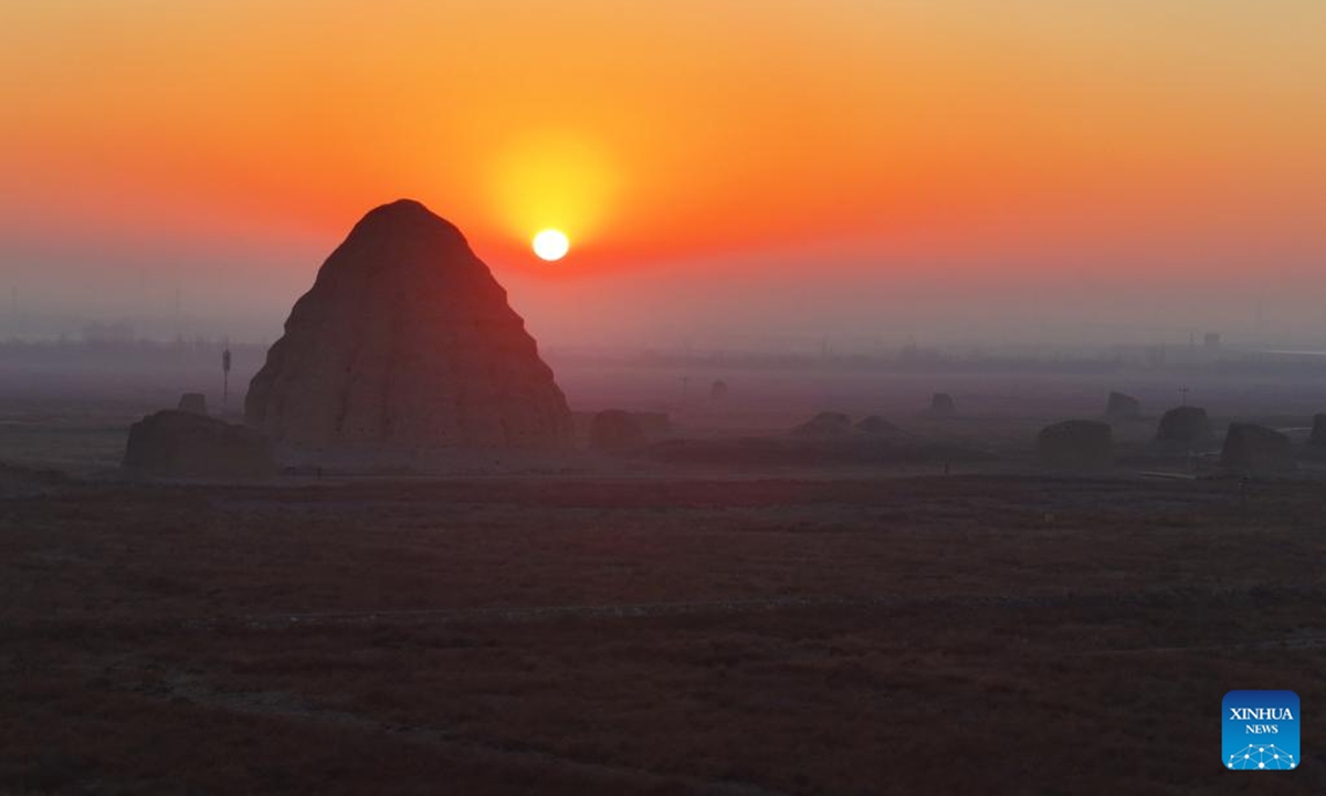 A drone photo taken on Dec. 28, 2025 shows a Xixia imperial tomb at sunrise in Yinchuan, northwest China's Ningxia Hui Autonomous Region. China's Xixia Imperial Tombs were officially added to the UNESCO World Heritage List on July 11, 2025 during the 47th session of the World Heritage Committee held in Paris, France. (Photo by Yuan Hongyan/Xinhua)