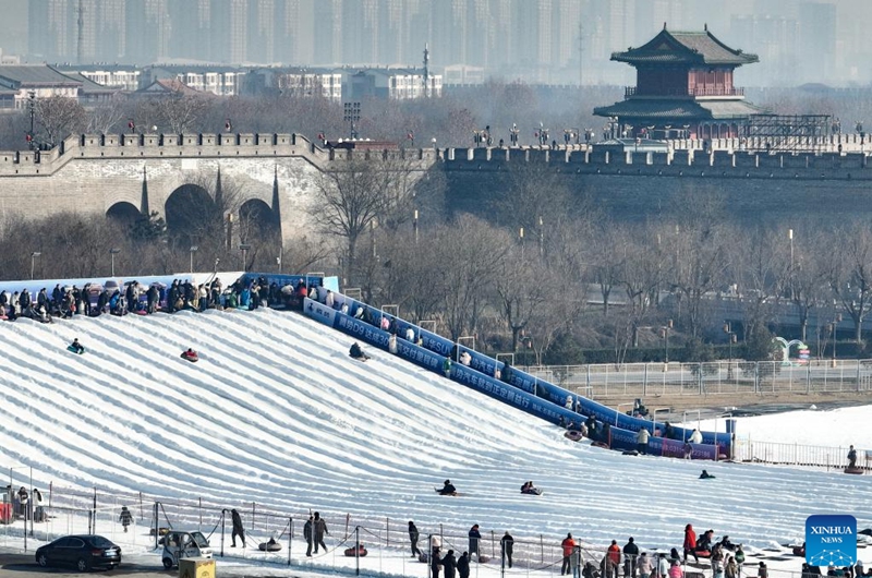 This aerial drone photo taken on Dec. 28, 2025 shows people playing in an ice-and-snow theme park in Zhengding County of north China's Hebei Province. (Photo by Zhang Xiaofeng/Xinhua)