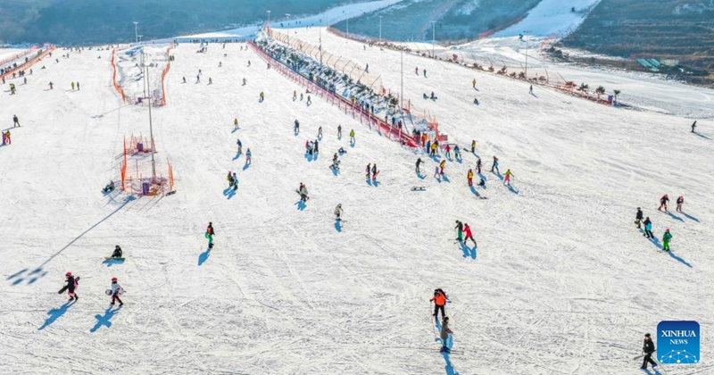 This aerial drone photo taken on Dec. 28, 2025 shows people skiing at a ski resort in Yutian County of north China's Hebei Province. (Photo by Liu Mancang/Xinhua)