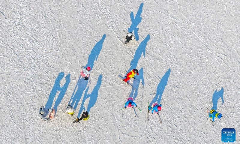 This aerial drone photo taken on Dec. 28, 2025 shows people skiing at a ski resort in Yutian County of north China's Hebei Province. (Photo by Liu Mancang/Xinhua)