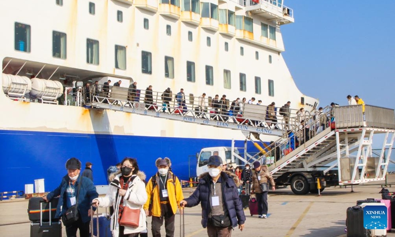 Tourists from South Korea get off from the Harmony Yungang cruise ship at Lianyungang Port in Lianyungang City, east China's Jiangsu Province, Dec. 28, 2025. A total of 255 South Korean tourists arrived in Lianyungang aboard the Harmony Yungang cruise ship, commencing a five-day New Year tour in China. This marks the largest group of South Korean travelers received at Lianyungang port passenger terminal since China's visa-free policy for South Korean citizens. (Photo by Wang Jianmin/Xinhua)